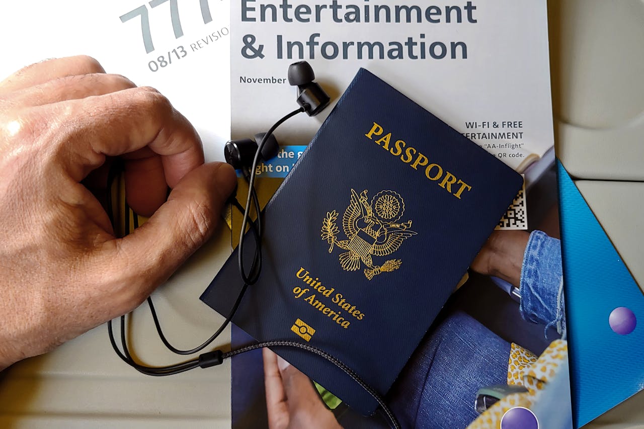 Crafting Captivating Headlines: Your awesome post title goes here Close-up of US passport with inflight magazine and headphones on an airplane seat, ready for travel.